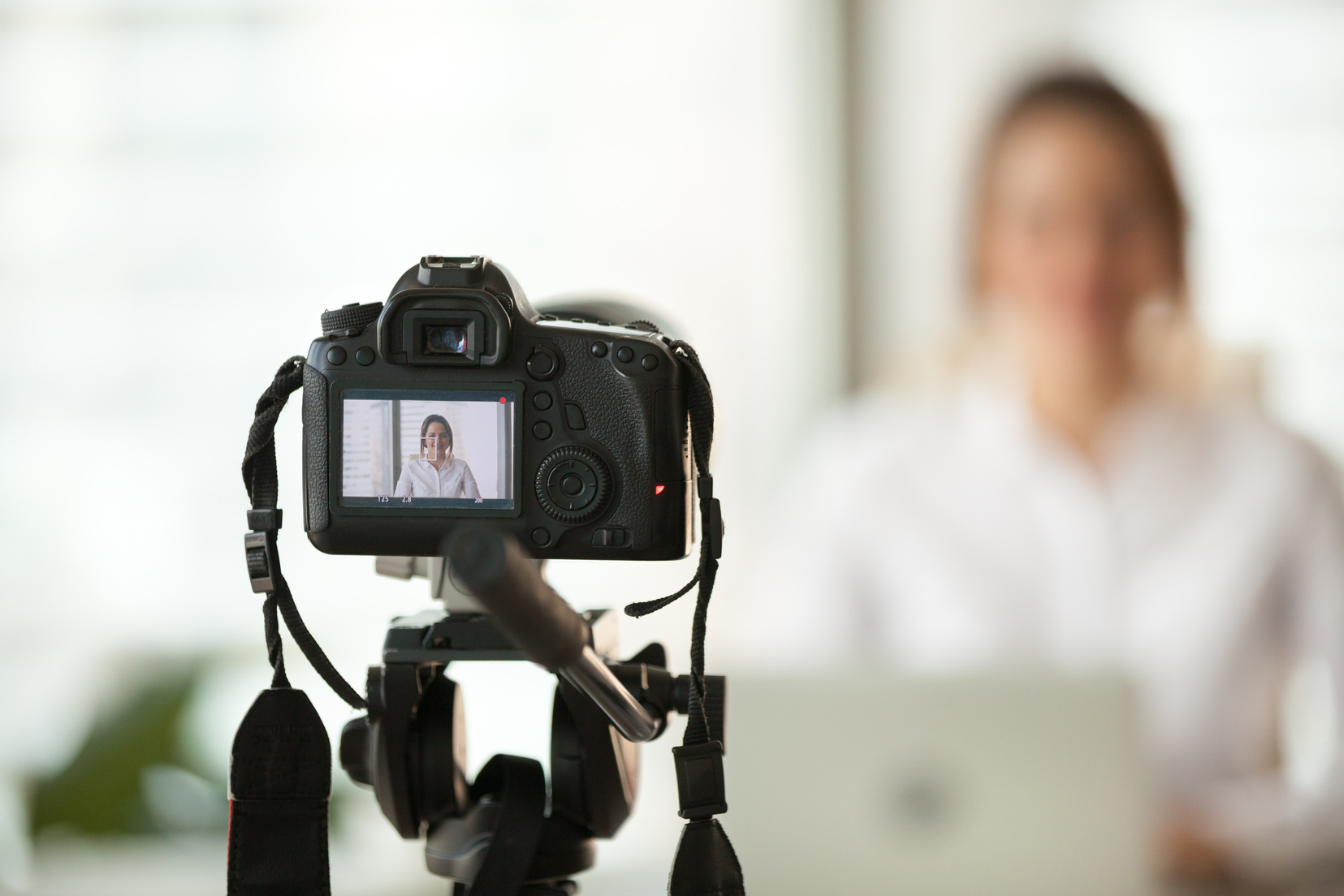 Professional dslr digital camera filming vlog of business woman vlogger